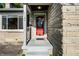 Close-up of the home's entrance, featuring a red door and stone facade at 6146 Burlington Ave, Indianapolis, IN 46220
