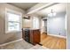 Kitchen area with granite countertops and a wine fridge complemented by warm lighting and wood floors at 6146 Burlington Ave, Indianapolis, IN 46220