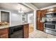 Modern kitchen features granite countertops, stainless steel appliances, and a built-in wine fridge at 6146 Burlington Ave, Indianapolis, IN 46220