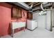 Functional laundry room with utility sink, cabinetry, and modern washer and dryer units at 6146 Burlington Ave, Indianapolis, IN 46220