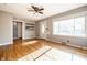 Sunlit living room featuring hardwood floors, neutral walls, and a ceiling fan at 6146 Burlington Ave, Indianapolis, IN 46220