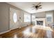 Bright living room with hardwood floors, fireplace, ceiling fan, and natural light at 6146 Burlington Ave, Indianapolis, IN 46220