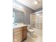 Well-lit bathroom with a shower over tub, vanity, and neutral tile flooring at 626 Tulip Poplar Ct, Mooresville, IN 46158