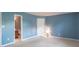 Serene bedroom with blue walls, neutral carpet, and natural light at 626 Tulip Poplar Ct, Mooresville, IN 46158