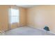 Bright bedroom featuring yellow walls, carpet, and a large window at 626 Tulip Poplar Ct, Mooresville, IN 46158