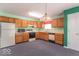 Functional kitchen featuring wood cabinets, a refrigerator, a microwave, and an electric stove at 626 Tulip Poplar Ct, Mooresville, IN 46158