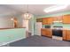 Cozy kitchen with wooden cabinets, a refrigerator, and an electric stove at 626 Tulip Poplar Ct, Mooresville, IN 46158