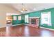 Cozy living room with wood floors, brick fireplace, and lots of natural light from the windows at 626 Tulip Poplar Ct, Mooresville, IN 46158