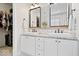Well-lit bathroom with dual sinks, granite countertops, white cabinets, and classic subway tile backsplash at 6528 Fountain Springs Blvd, Indianapolis, IN 46236