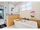 Modern bathroom featuring a soaking tub, a glass-enclosed shower, stylish finishes, and natural light at 6528 Fountain Springs Blvd, Indianapolis, IN 46236