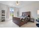 Comfortable bedroom featuring a wooden bedframe, neutral walls, plush carpet, and plenty of natural light at 6528 Fountain Springs Blvd, Indianapolis, IN 46236