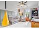 Cozy Bedroom with ample natural light, a pale green accent wall, a crib, and comfortable seating at 6528 Fountain Springs Blvd, Indianapolis, IN 46236