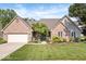 Charming brick home with a well-manicured lawn and a welcoming front entrance at 6528 Fountain Springs Blvd, Indianapolis, IN 46236