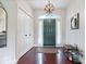 Bright foyer with hardwood floors, closet, stylish light fixture and a green front door at 6528 Fountain Springs Blvd, Indianapolis, IN 46236
