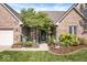 Close-up of the house's entrance, landscaped front garden, and brick facade at 6528 Fountain Springs Blvd, Indianapolis, IN 46236