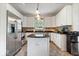 Bright kitchen featuring a functional center island, stainless appliances, white cabinets, and appealing backsplash at 6528 Fountain Springs Blvd, Indianapolis, IN 46236