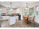 Cozy kitchen with white cabinetry, granite counters, a breakfast bar and adjacent breakfast nook at 6528 Fountain Springs Blvd, Indianapolis, IN 46236