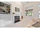 Bright living room features a fireplace, built-in shelving, and large windows at 6528 Fountain Springs Blvd, Indianapolis, IN 46236