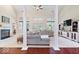 Open-concept living room with pillars, fireplace, and views into dining area at 6528 Fountain Springs Blvd, Indianapolis, IN 46236