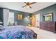 Spacious main bedroom featuring dark walls, plush carpet, stylish furnishings, and a barn door to the bathroom at 6528 Fountain Springs Blvd, Indianapolis, IN 46236