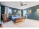 Spacious main bedroom with multiple windows, dark walls, stylish furnishings, and plush carpet at 6528 Fountain Springs Blvd, Indianapolis, IN 46236