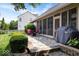 Stone patio with outdoor seating, grill, and manicured landscaping at 6528 Fountain Springs Blvd, Indianapolis, IN 46236