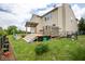 Large, green backyard with a wooden deck and patio area, perfect for entertaining at 6532 Amherst Way, Zionsville, IN 46077
