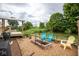 View of a stone patio with a brick firepit and outdoor seating at 6532 Amherst Way, Zionsville, IN 46077