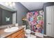 Bathroom with a vanity, toilet, and a colorful floral shower curtain adding a vibrant touch at 6532 Amherst Way, Zionsville, IN 46077