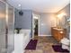 Bathroom with a large glass door shower, soaking tub, double sinks, and stylish lighting at 6532 Amherst Way, Zionsville, IN 46077