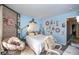Bedroom featuring modern decor, a full-size bed, and a cozy seating area at 6532 Amherst Way, Zionsville, IN 46077