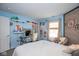 Stylish bedroom with light blue walls, unique decor, and comfortable seating area at 6532 Amherst Way, Zionsville, IN 46077