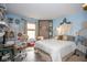 Bright bedroom with light blue walls, stylish decor, and a cozy seating arrangement at 6532 Amherst Way, Zionsville, IN 46077