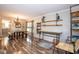 Open dining room featuring a rustic table with benches, chandelier, and decorative shelving at 6532 Amherst Way, Zionsville, IN 46077