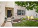 A cute front porch with cheerful decorations and decorative chairs at 6532 Amherst Way, Zionsville, IN 46077
