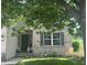 Charming brick home with well-maintained lawn, mature tree, and cheerful decorative details at 6532 Amherst Way, Zionsville, IN 46077