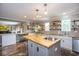 Stylish kitchen with butcher block countertops, kitchen island, and open shelving at 6532 Amherst Way, Zionsville, IN 46077