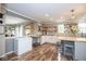 Modern kitchen with white cabinets, butcher block countertops, and open shelving for storage at 6532 Amherst Way, Zionsville, IN 46077