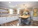 Spacious kitchen featuring butcher block countertops, open shelving, and a center island with seating at 6532 Amherst Way, Zionsville, IN 46077