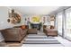 Bright living room with fireplace, built-in shelving, and access to the backyard through glass doors at 6532 Amherst Way, Zionsville, IN 46077