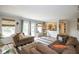 Comfortable living room featuring a large sectional sofa, hardwood floors, and lots of natural light at 6532 Amherst Way, Zionsville, IN 46077
