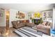 Inviting living room featuring a fireplace, built-in shelving, and a cozy brown sectional at 6532 Amherst Way, Zionsville, IN 46077