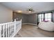 Open concept living room with staircase and a huge white round beanbag chair in the corner at 6532 Amherst Way, Zionsville, IN 46077