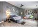 Spacious main bedroom featuring unique wall decor, ceiling fan, and wood-look flooring at 6532 Amherst Way, Zionsville, IN 46077