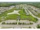 Aerial view showcasing a community with a pond, playground, and basketball court at 6670 Shooting Star Dr, Whitestown, IN 46075
