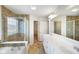 Bathroom features white cabinetry, dual sinks, tile flooring, shower, and soaking tub at 6670 Shooting Star Dr, Whitestown, IN 46075
