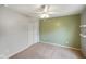 This bedroom features a ceiling fan, a neutral carpet, and closet with standard sliding doors at 6670 Shooting Star Dr, Whitestown, IN 46075