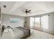 Serene bedroom with tray ceilings, natural light from the windows, and a ceiling fan at 6670 Shooting Star Dr, Whitestown, IN 46075