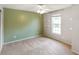 Bedroom showcasing neutral paint, carpet, a ceiling fan, and large window at 6670 Shooting Star Dr, Whitestown, IN 46075