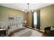 Cozy bedroom with chandelier lighting, neutral colors, a plush bed and a window with curtains at 6670 Shooting Star Dr, Whitestown, IN 46075